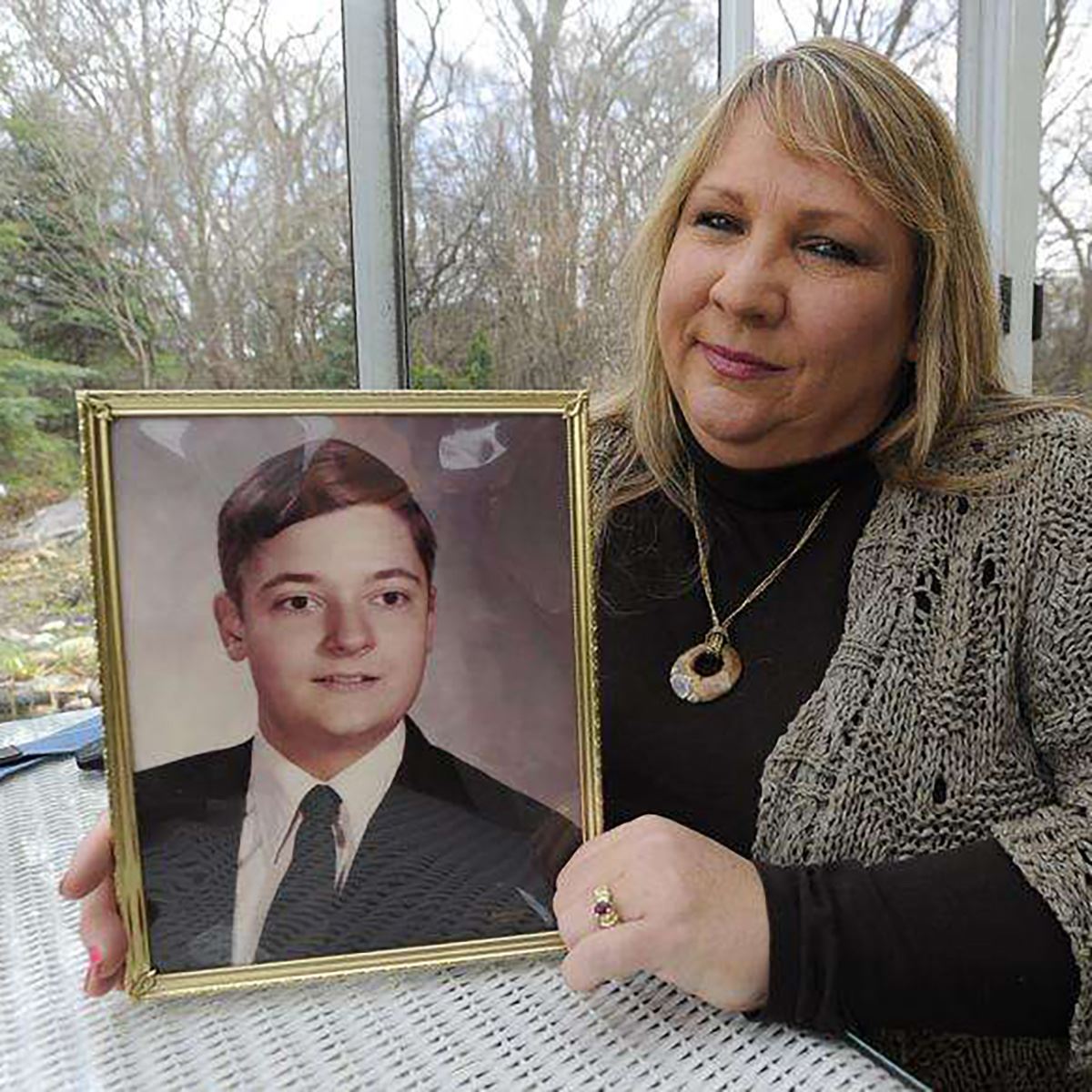  Pamela Olander holds a 1975 photo of John Trout